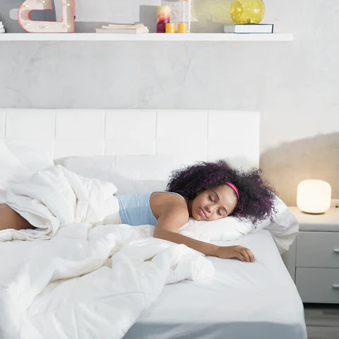woman sleeping soundly in her bed