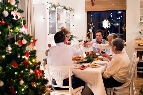 a family eating at the dinner table during the Christmas season