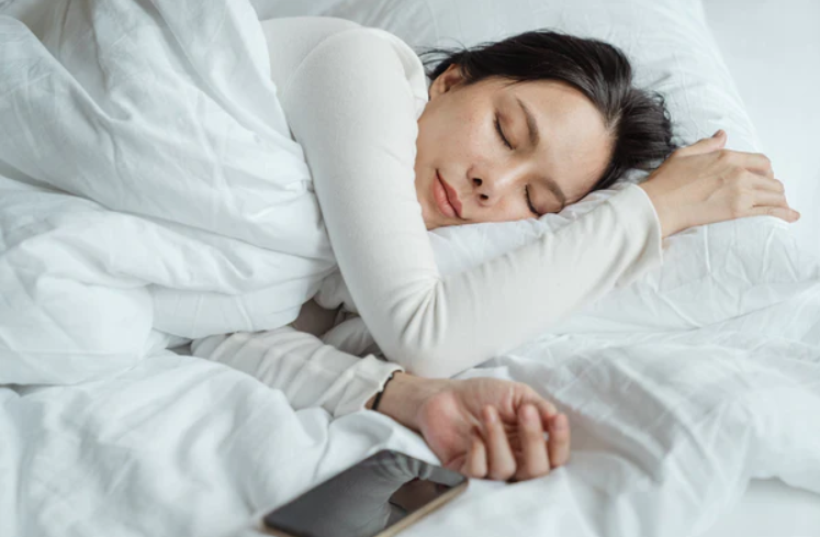 woman sleeping in her bed comfortably