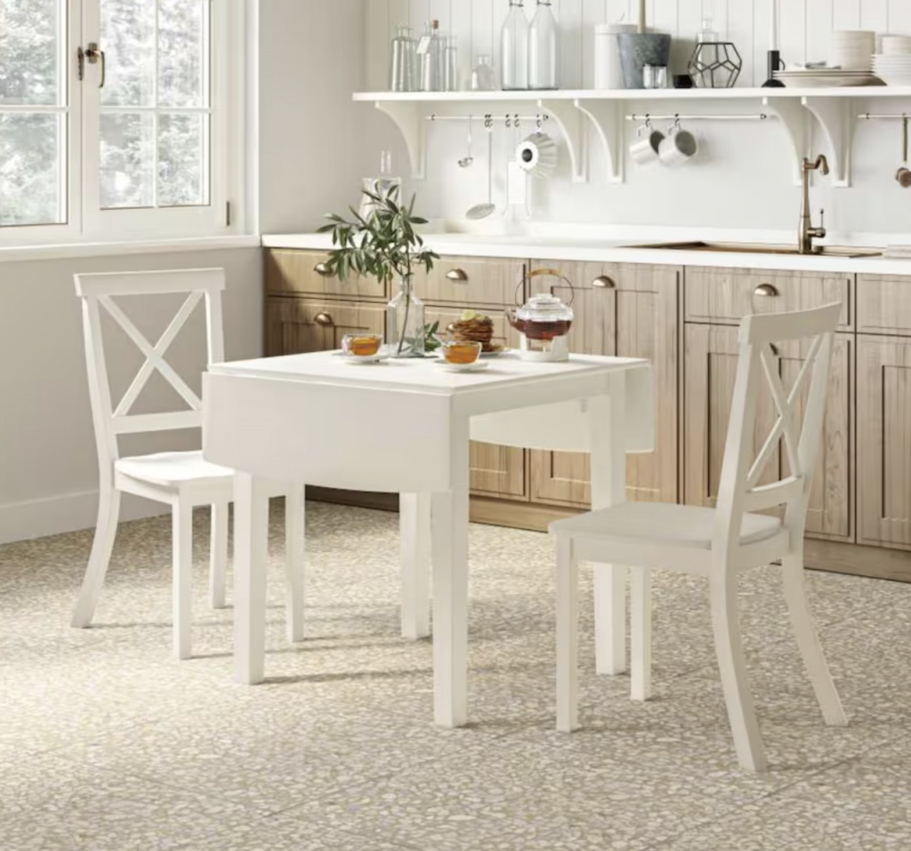 white breakfast nook table with end extensions and two chairs