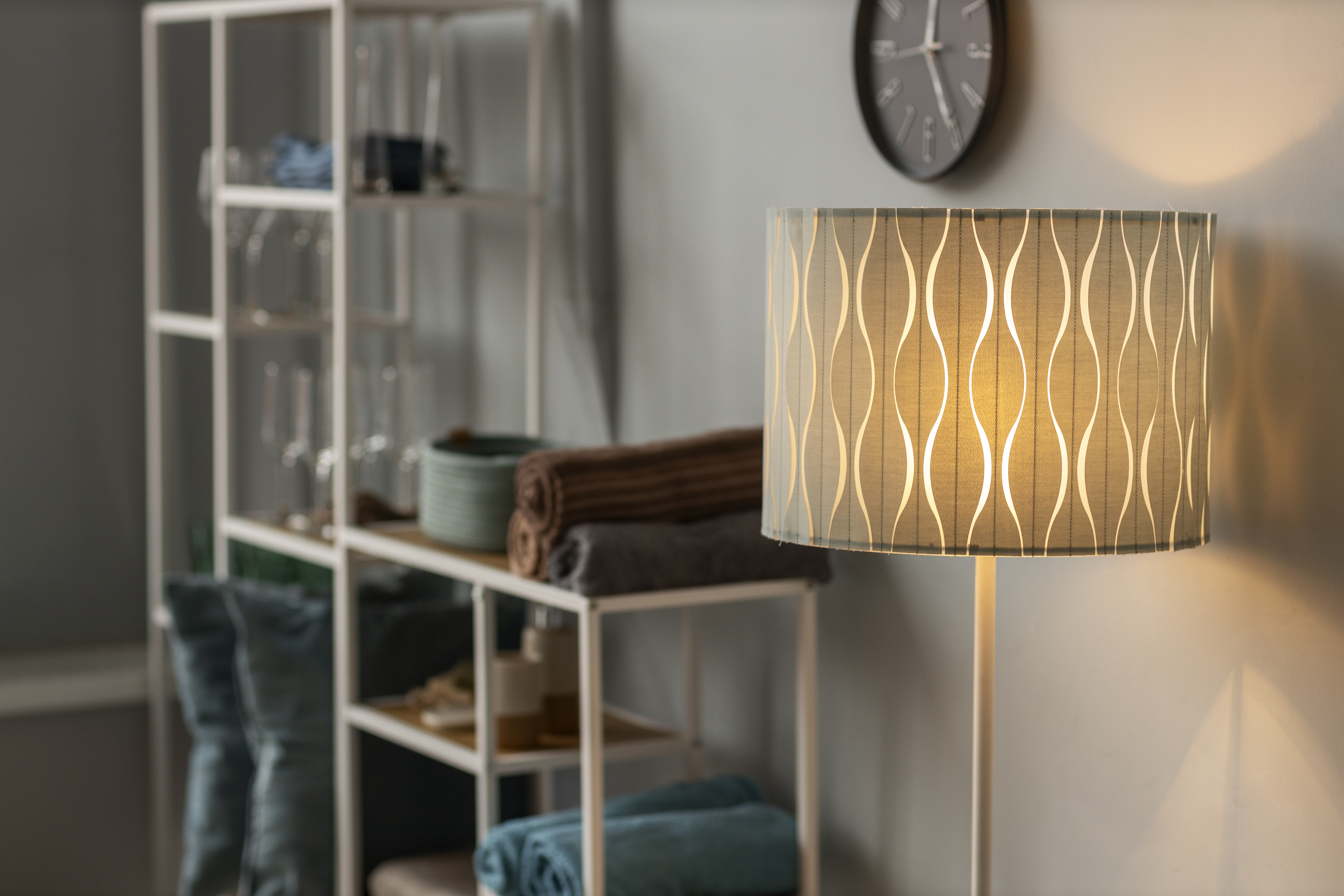 lamp turned on with metal cabinets in the background