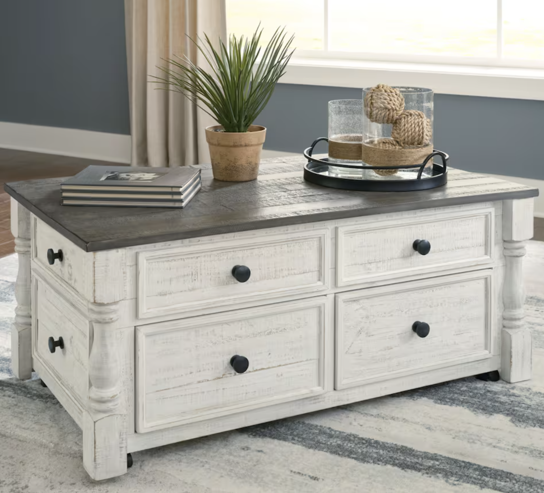 white farm-style coffee table with dark top and storage
