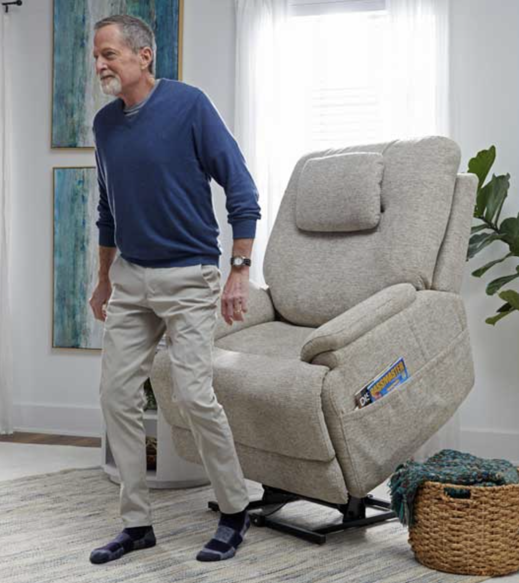 man walking out of a lift chair that is fully lifted