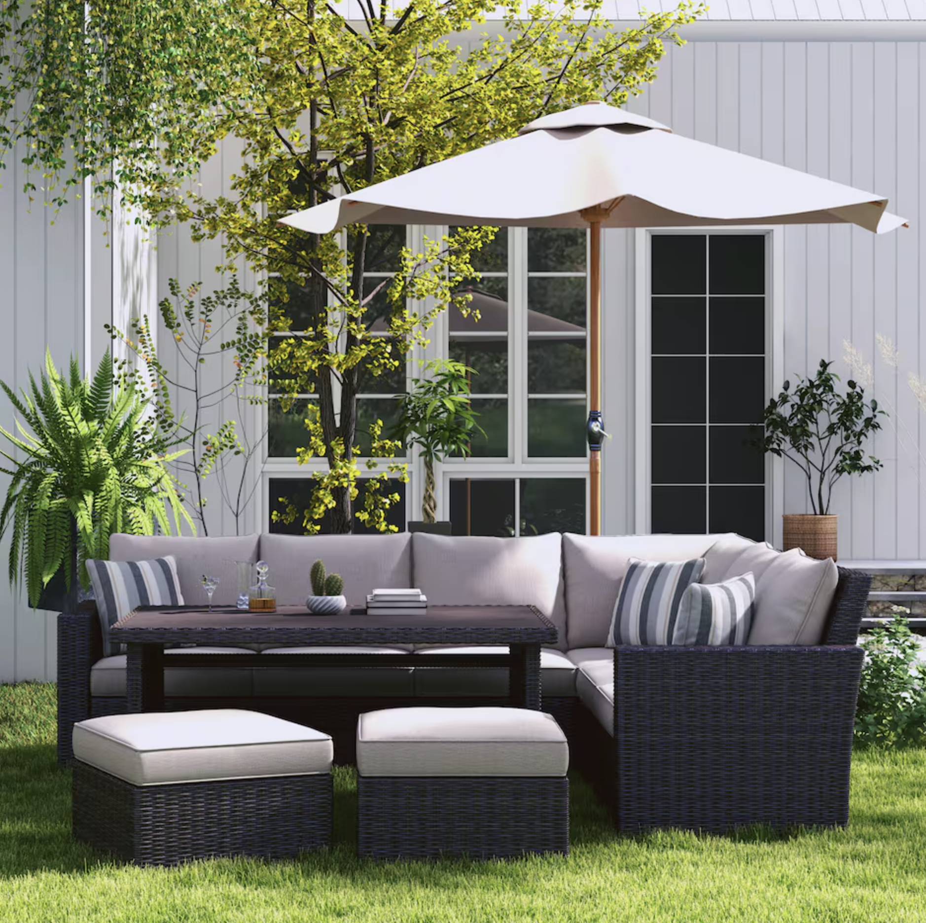 dark wicker outdoor furniture set with light gray cushions and two ottomans