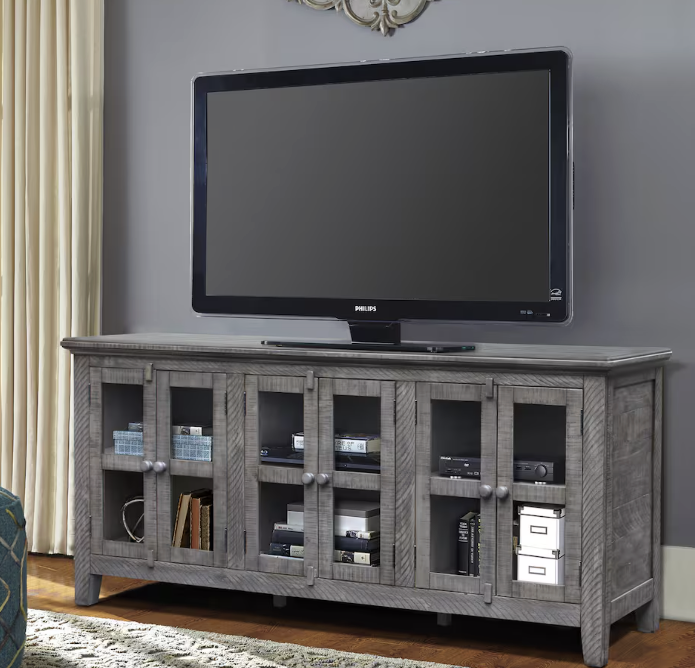 gray wood entertainment console and large TV